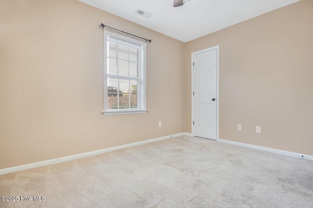 carpeted empty room featuring ceiling fan