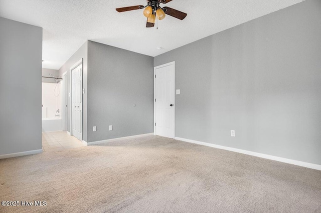 carpeted empty room with a textured ceiling and ceiling fan