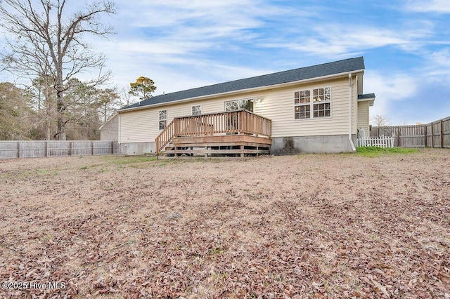 back of property with a wooden deck