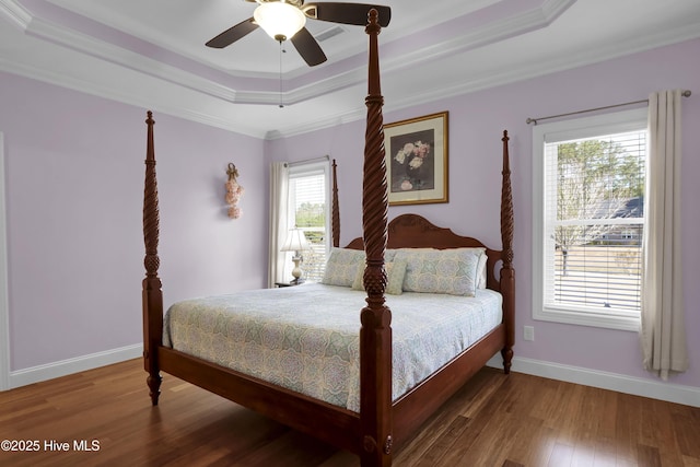 bedroom featuring crown molding, ceiling fan, a tray ceiling, and hardwood / wood-style floors