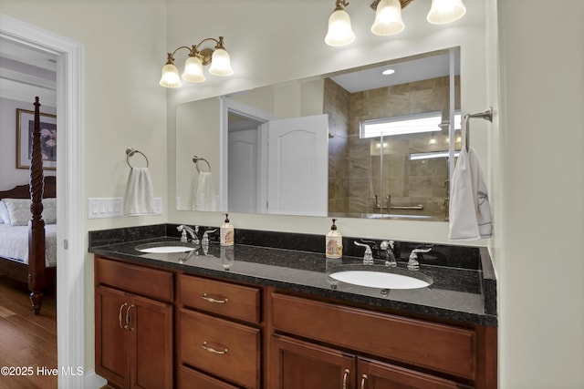 bathroom with an enclosed shower, vanity, and wood-type flooring