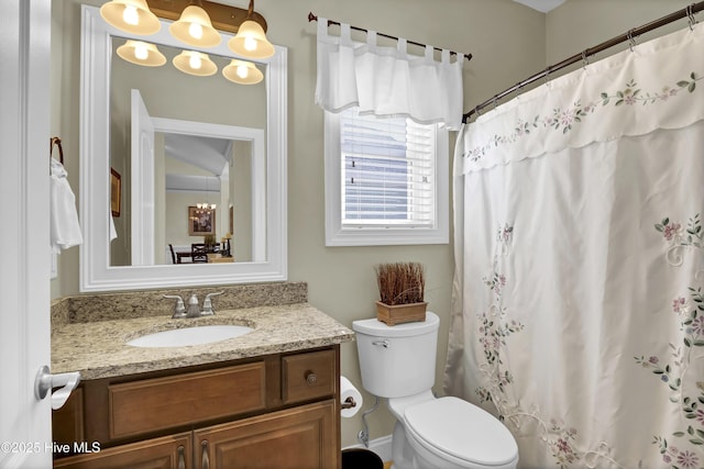 bathroom featuring vanity, toilet, and curtained shower