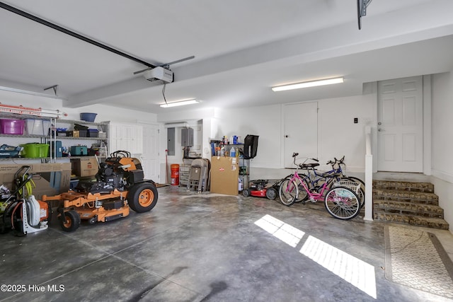 garage with a garage door opener and electric panel