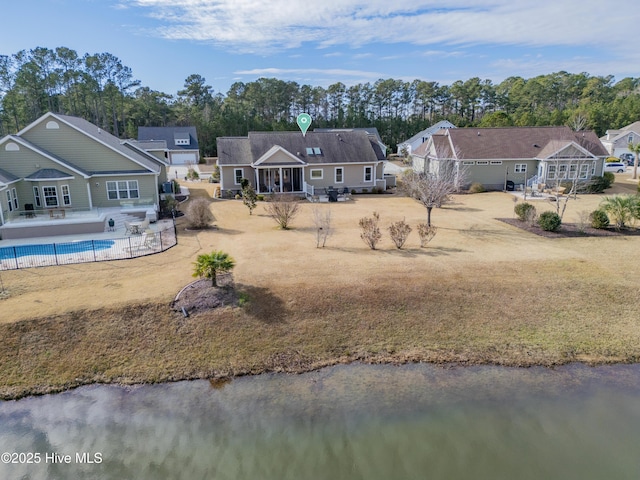 rear view of property with a water view and a patio area