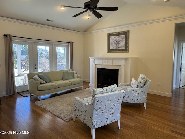 living room featuring crown molding, lofted ceiling, a fireplace, and dark wood-type flooring