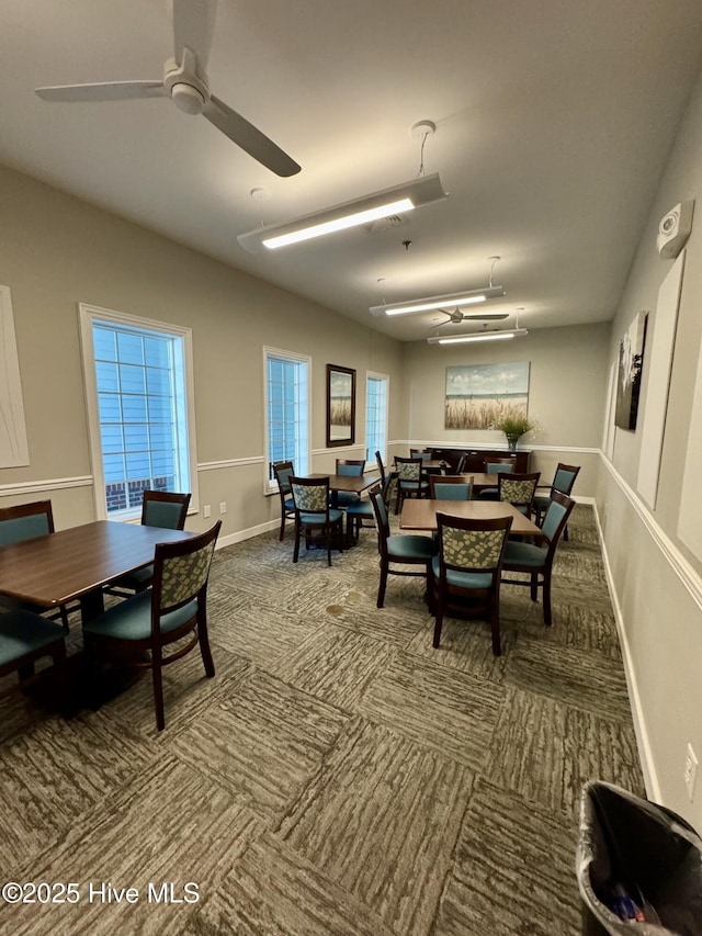 dining space featuring carpet and ceiling fan