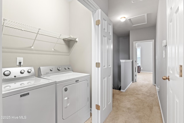 clothes washing area featuring washer and dryer and light colored carpet