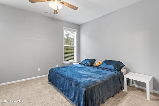 bedroom with ceiling fan and light carpet