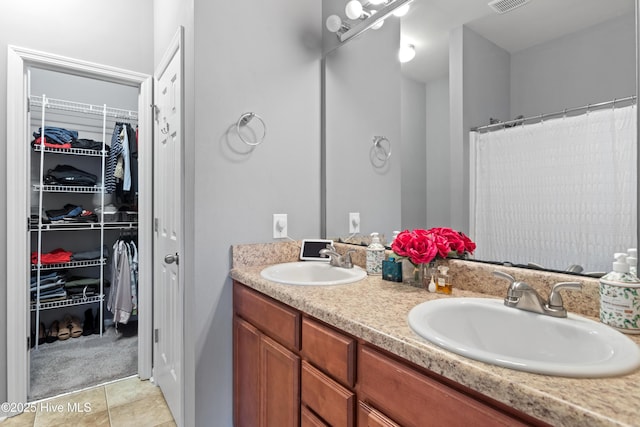 bathroom featuring tile patterned flooring, vanity, and a shower with curtain