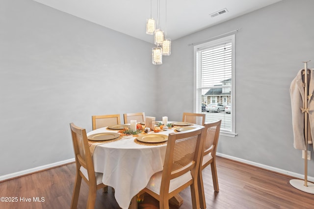 dining space featuring dark hardwood / wood-style flooring and a healthy amount of sunlight