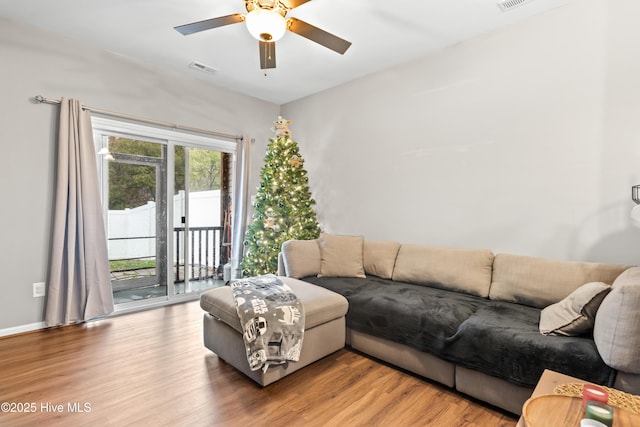 living room with hardwood / wood-style flooring and ceiling fan