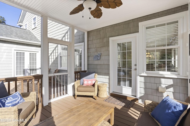 wooden deck featuring a ceiling fan and french doors