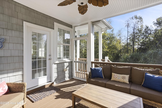 sunroom featuring a ceiling fan