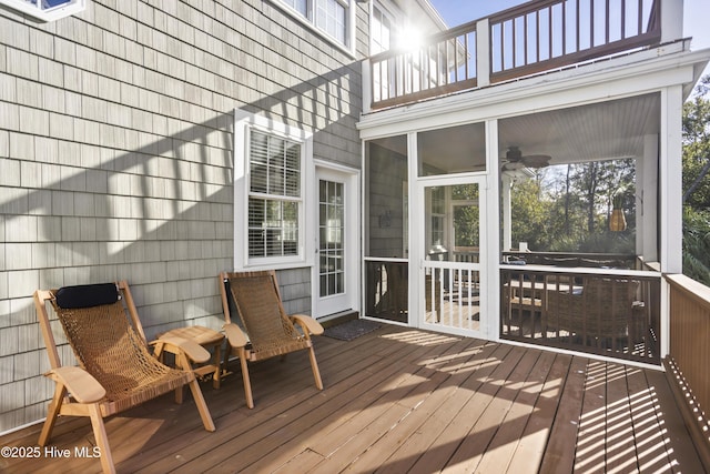 wooden deck with a sunroom