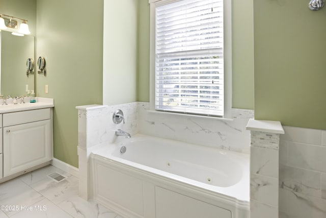 bathroom featuring visible vents, marble finish floor, a tub with jets, and vanity