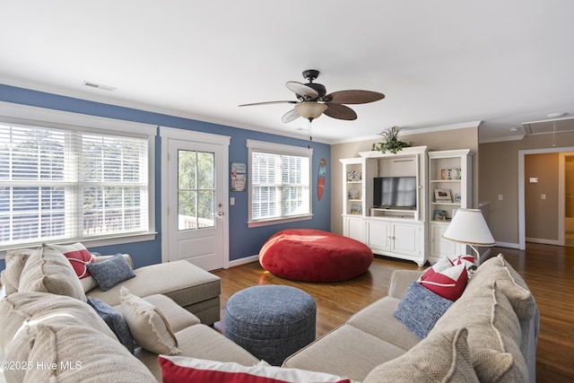 living area featuring baseboards, wood finished floors, visible vents, and attic access