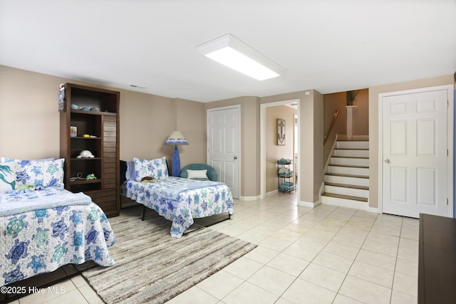 bedroom with light tile patterned floors, baseboards, and visible vents