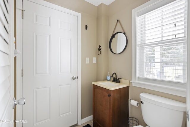 half bathroom with toilet and vanity