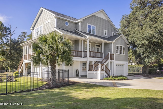 view of front facade with a garage, concrete driveway, stairway, and a front yard