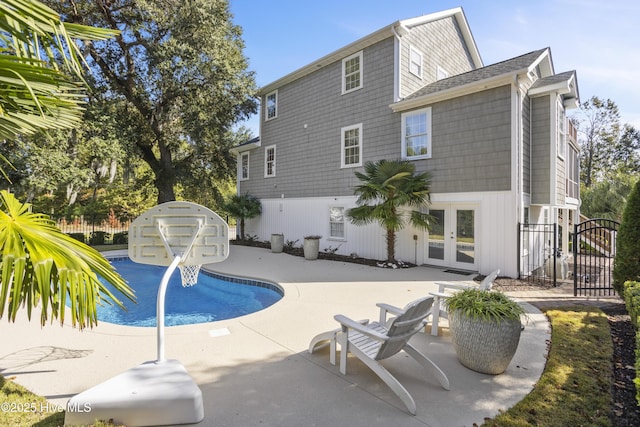 view of swimming pool with a fenced in pool, french doors, a patio, a gate, and fence