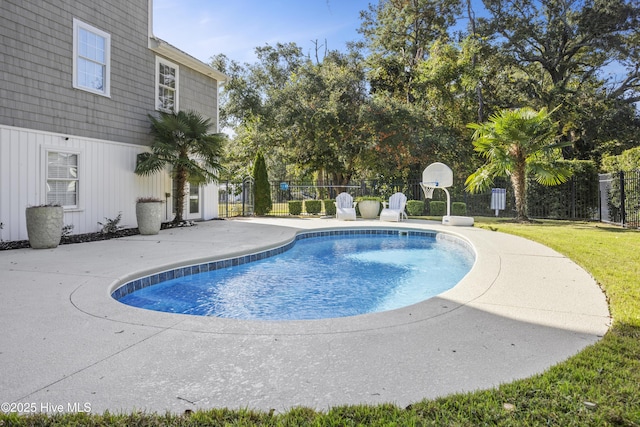 view of swimming pool with a patio area, a fenced in pool, fence, and a lawn