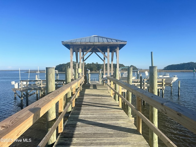 dock area with a water view and boat lift