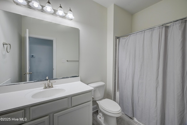 bathroom featuring curtained shower, vanity, and toilet