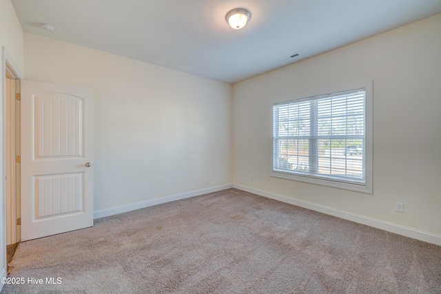 empty room featuring light colored carpet