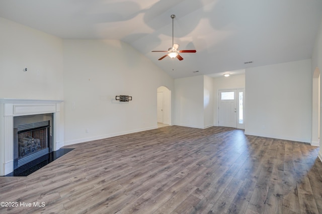 unfurnished living room featuring ceiling fan, light hardwood / wood-style flooring, and vaulted ceiling