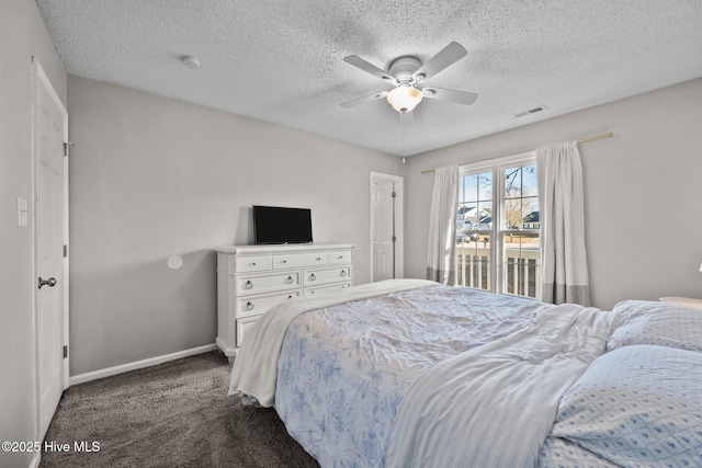 carpeted bedroom featuring access to exterior, ceiling fan, and a textured ceiling