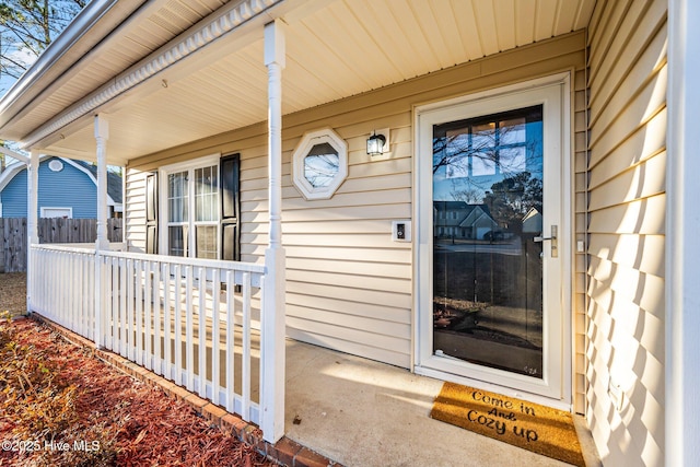 view of exterior entry featuring a porch