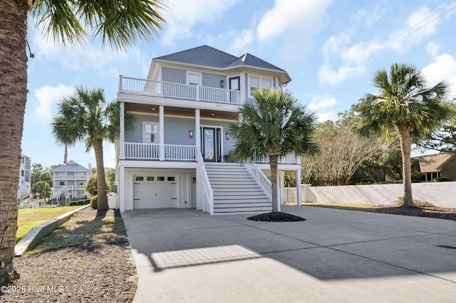 coastal inspired home with a porch and a garage