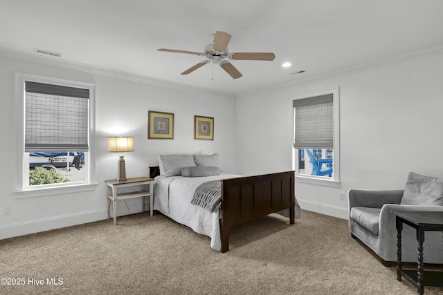 carpeted bedroom featuring ceiling fan and crown molding