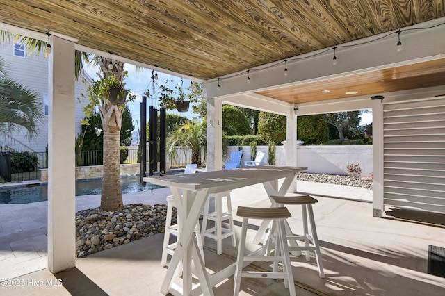 view of patio / terrace with a fenced in pool