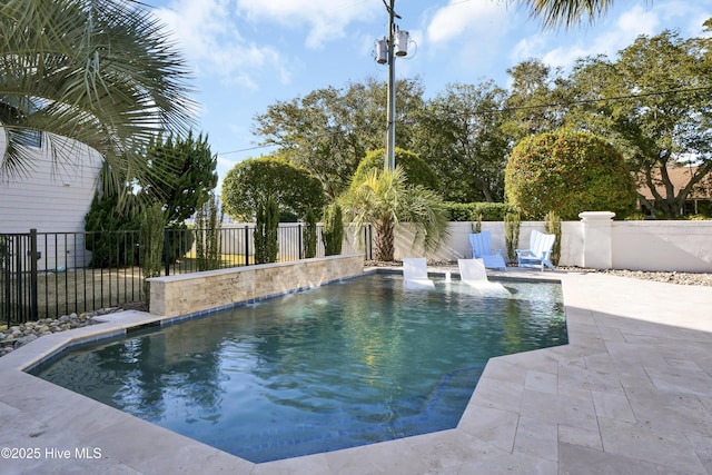 view of pool with pool water feature and a patio