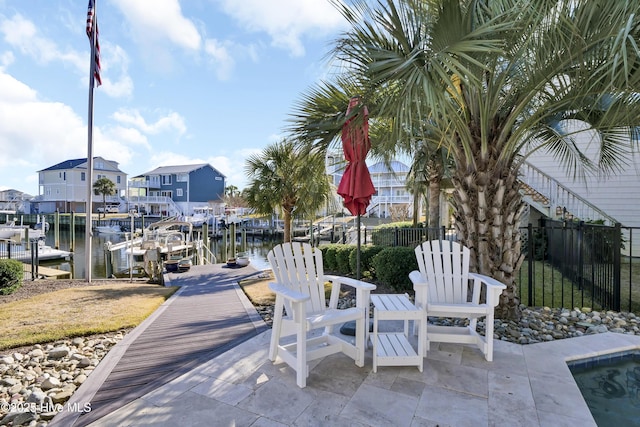 view of patio / terrace featuring a dock and a water view