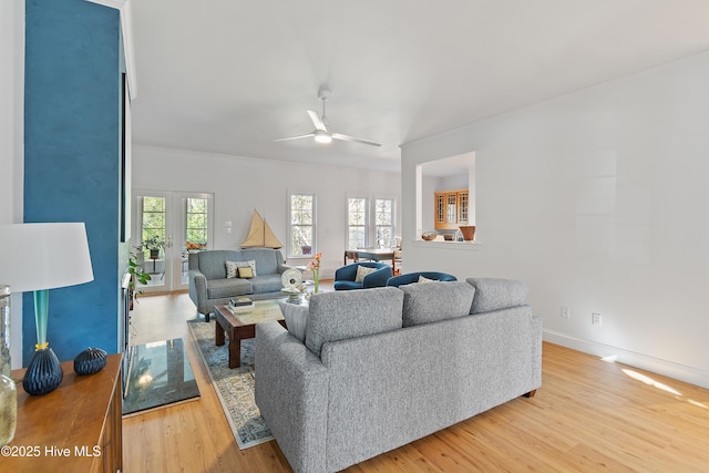 living room featuring french doors, ceiling fan, a healthy amount of sunlight, and hardwood / wood-style flooring