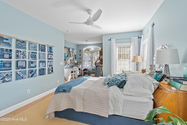 bedroom with ceiling fan and wood-type flooring