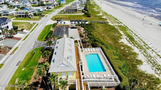 drone / aerial view with a beach view and a water view