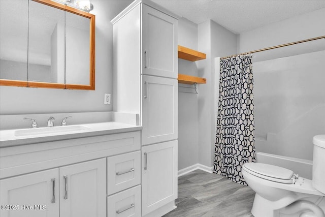 full bathroom with a textured ceiling, vanity, shower / tub combo, and toilet