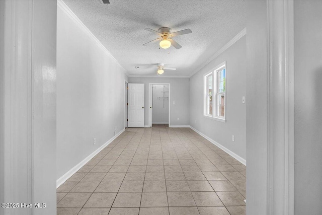 tiled spare room with ceiling fan, a textured ceiling, and ornamental molding