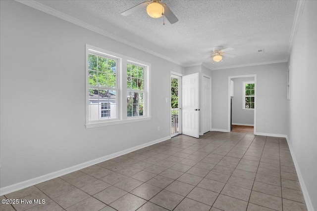 tiled spare room with a textured ceiling, ceiling fan, and crown molding