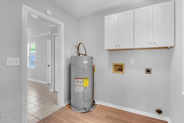 washroom featuring electric dryer hookup, cabinets, electric water heater, washer hookup, and a textured ceiling