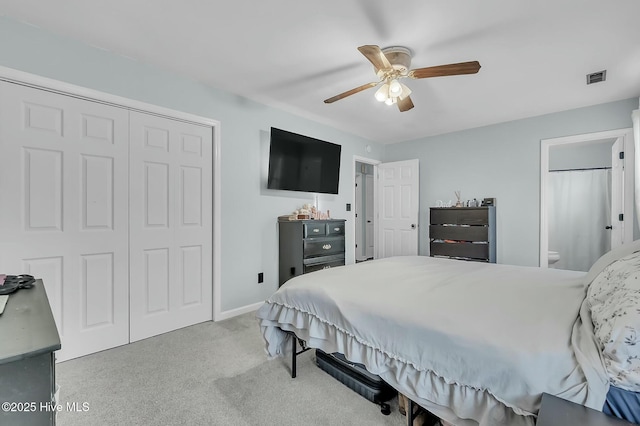 bedroom featuring ceiling fan, a closet, and light carpet