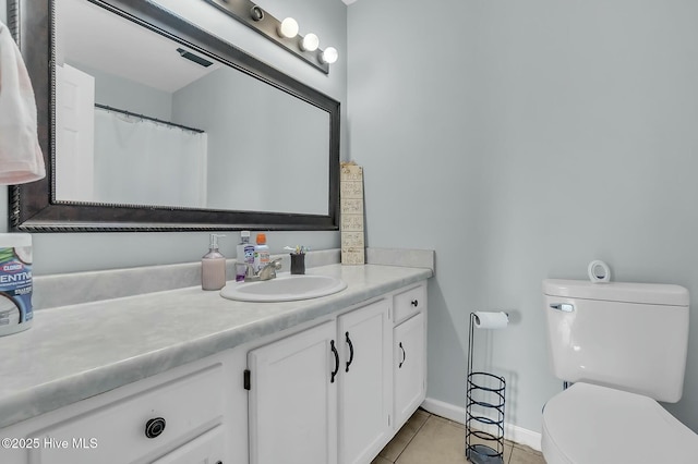 bathroom featuring tile patterned floors, vanity, and toilet