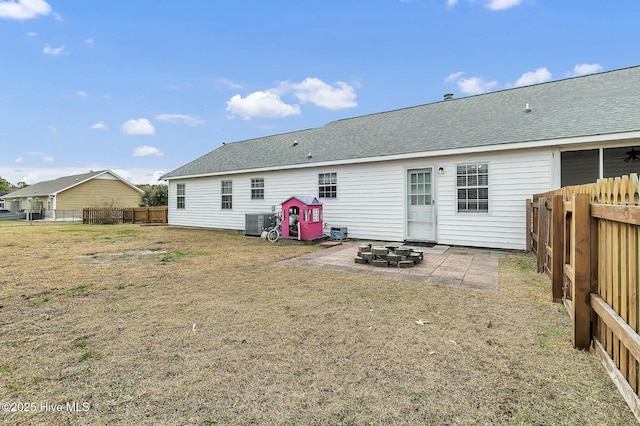 rear view of house featuring a lawn, a patio area, and central air condition unit