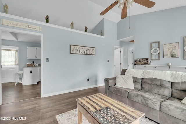 living room featuring ceiling fan, dark wood-type flooring, and vaulted ceiling