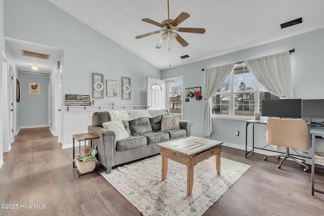 living room featuring ceiling fan, vaulted ceiling, and hardwood / wood-style flooring