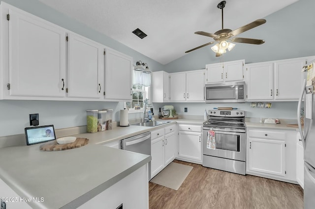 kitchen with white cabinets and appliances with stainless steel finishes