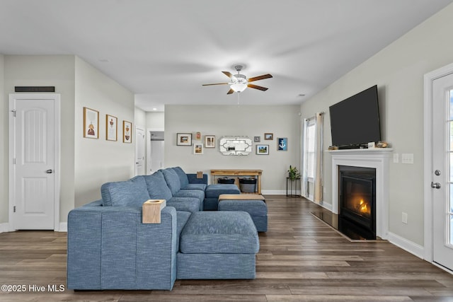 living room with ceiling fan and dark hardwood / wood-style floors